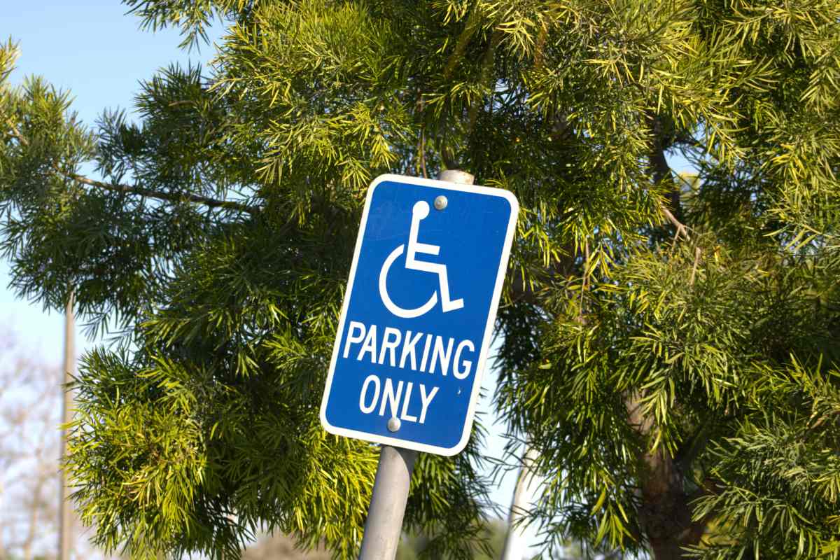 Blue and white ADA sign to indicate a reserved parking space for those with disabilities near Greeneville, TN