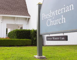 Quality outdoor church signs featuring the church’s denomination and Sunday worship time in the property’s yard at Greeneville Signs near Greeneville, TN