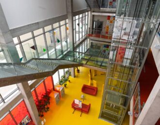 A unique interior for a commercial office building with fun wall-sized art and colorful flooring at Greeneville Signs near Greeneville, TN