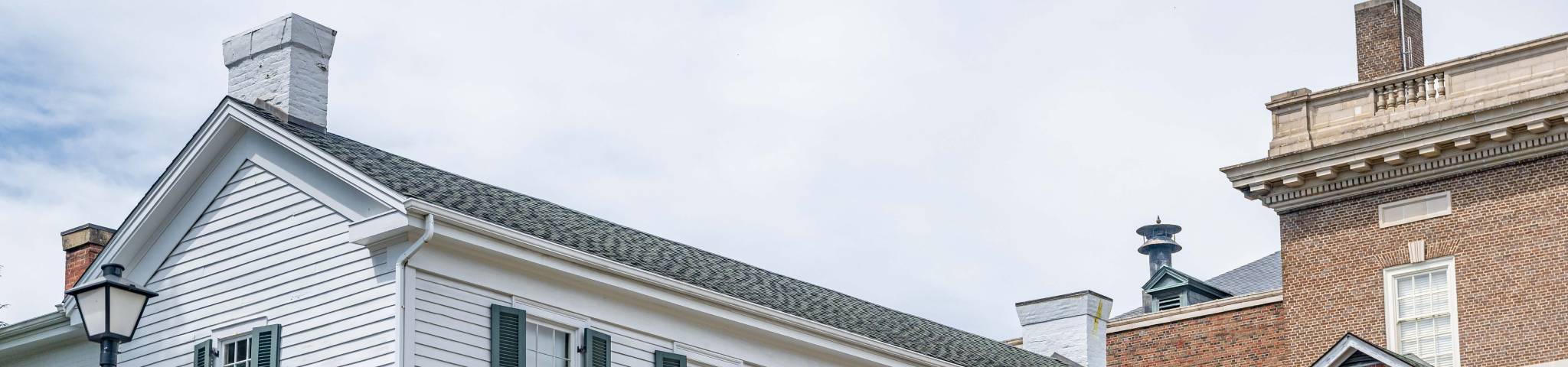 An image of gorgeous historical architecture in Greeneville, Tennessee, with greenery and partly cloudy skies