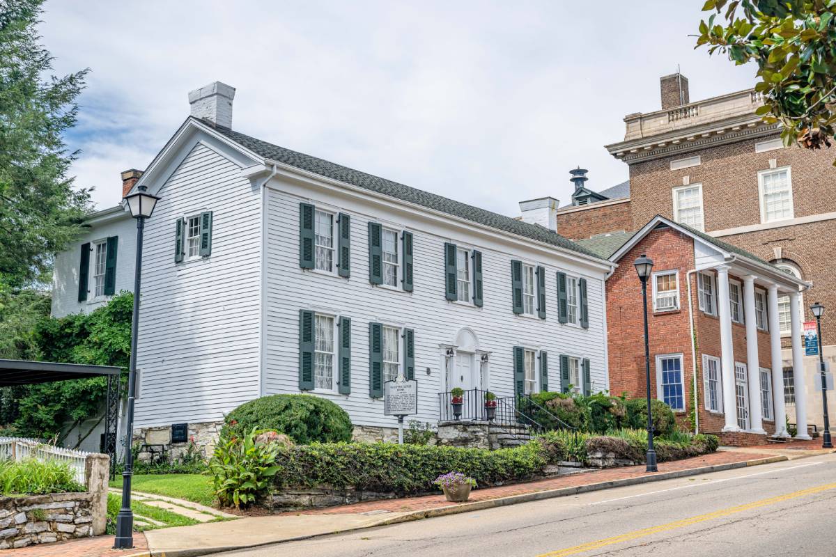 An image of gorgeous historical architecture in Greeneville, Tennessee, with greenery and partly cloudy skies